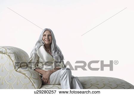 Stock Photo - Senior Woman on Chaise Lounge. Fotosearch