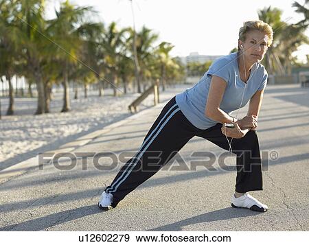 Senior woman stretching on tropical beach View Large Photo Image Stock Photo - Senior woman stretching on tropical beach. Fotosearch