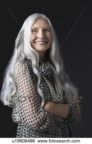Stock Photograph - Senior Woman with Arms Folded, smiling. Fotosearch