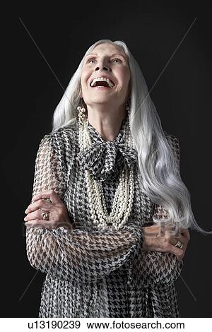 Senior Woman with Arms Folded, laughing, looking up View Large Photo Image Stock Photo - Senior Woman with Arms Folded, laughing, looking up. Fotosearch