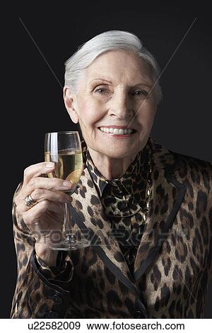Stock Photo - Senior woman with glass of white wine. Fotosearch