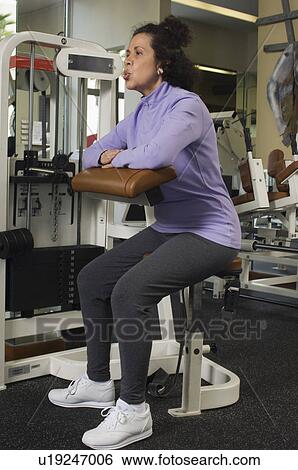 Senior Woman Working Out in Gym View Large Photo Image Stock Photograph - Senior Woman Working Out in Gym. Fotosearch