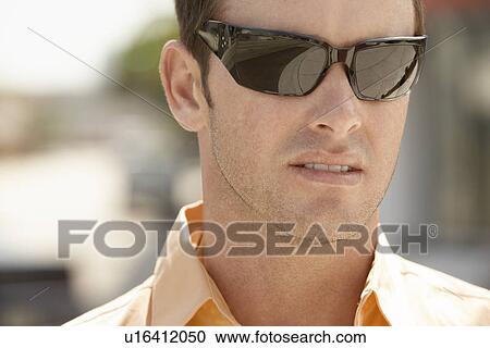 Serious man wearing sunglasses, portrait, close-up View Large Photo Image Stock Image - Serious man wearing sunglasses, portrait, close-up. Fotosearch