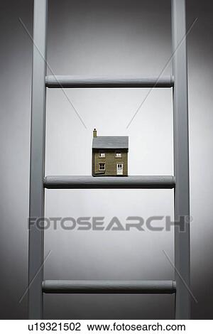 Stock Image - Small model of house on ladder. Fotosearch