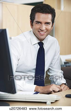 Smiling businessman in office, portrait View Large Photo Image Stock Image - Smiling businessman in office, portrait. Fotosearch
