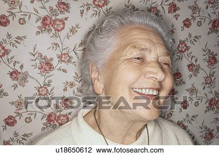 Stock Image - Smiling elderly woman, portrait, close-up. Fotosearch