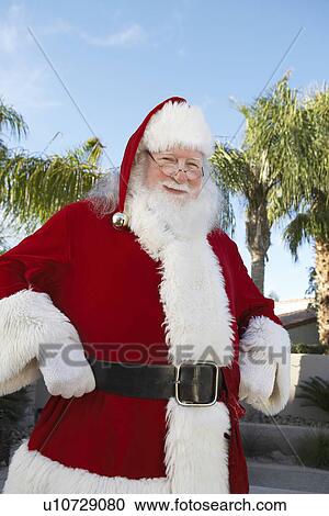 Smiling Santa Claus standing outside With Palm Trees View Large Photo Image Stock Image - Smiling Santa Claus standing outside With Palm Trees. Fotosearch