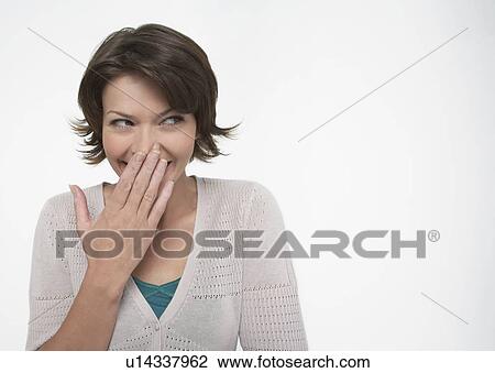 Smiling Woman, covering mouth with hand View Large Photo Image Stock Image - Smiling Woman, covering mouth with hand. Fotosearch