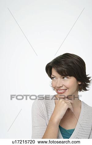 Smiling Woman looking to side, hand on chin View Large Photo Image Stock Image - Smiling Woman looking to side, hand on chin. Fotosearch