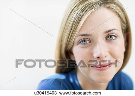 Stock Image - Smiling Young Woman, portrait, close up. Fotosearch