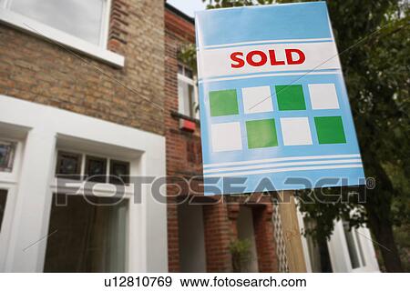 Sold sign in front of house View Large Photo Image Stock Photo - Sold sign in front of house. Fotosearch
