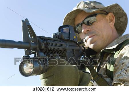 Soldier aiming rifle, outdoors, (close-up) View Large Photo Image Stock Image - Soldier aiming rifle, outdoors, (close-up). Fotosearch