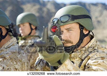 Soldier aiming rifle, outdoors, (close-up) View Large Photo Image Stock Photo - Soldier aiming rifle, outdoors, (close-up). Fotosearch