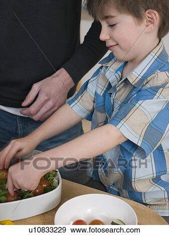 Stock Photo - Son Helping Father in Kitchen. Fotosearch