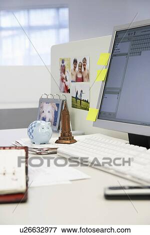 Stock Photo - Souvenirs on Desk by computer in office. Fotosearch