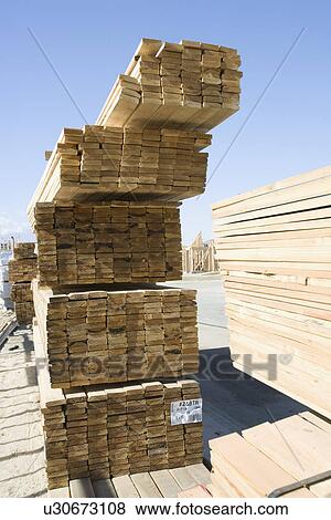 Stock Photo - Stacks of planks for new house. Fotosearch
