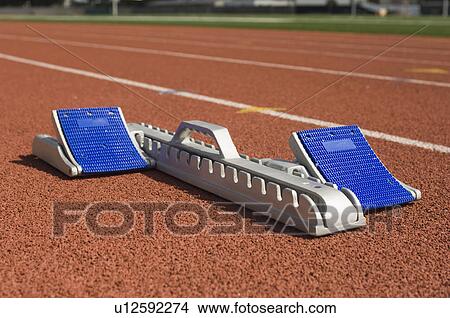 Picture - Starting block on running track. Fotosearch