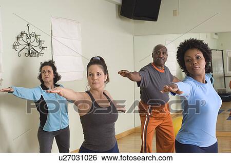 Stock Photograph - Stretching in Yoga Class. Fotosearch