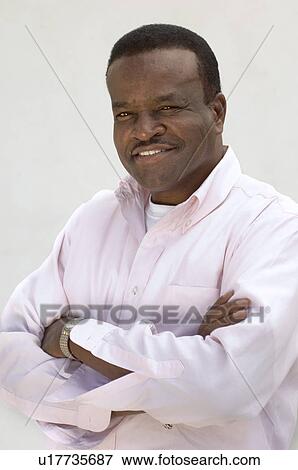 Studio portrait of man smiling View Large Photo Image Stock Photo - Studio portrait of man smiling. Fotosearch