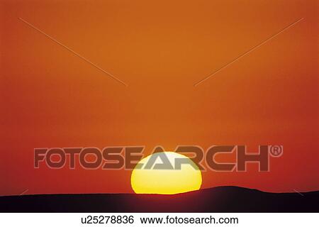 Stock Photograph - Sun setting. Fotosearch