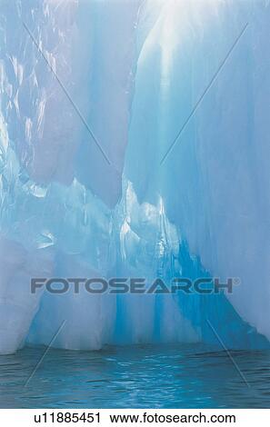 Stock Image - Sun shining through iceberg. Fotosearch