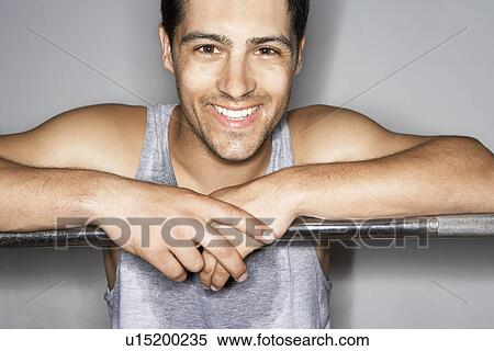 Sweaty man resting on barbell after workout, portrait View Large Photo Image Stock Photography - Sweaty man resting on barbell after workout, portrait. Fotosearch