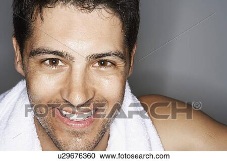 Stock Image - Sweaty Man with towel around shoulders, portrait, close up. Fotosearch