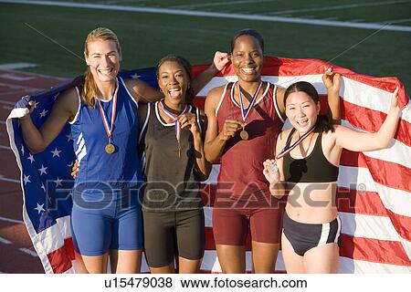 Stock Photo - Team of American female athletes celebrating victory. Fotosearch