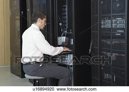Technician working in server room View Large Photo Image Stock Image - Technician working in server room. Fotosearch