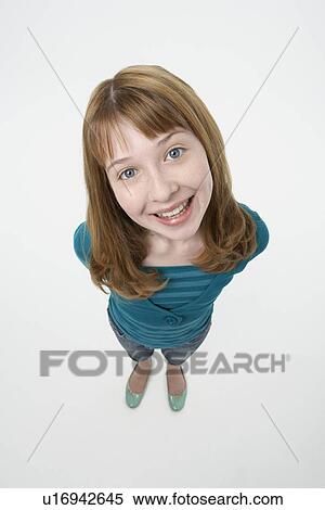 Stock Photography - Teenage Girl, hands behind back, Smiling, elevated view. Fotosearch