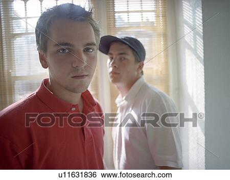 Teenagers (16-18) standing in front of window, portrait View Large Photo Image Stock Photograph - Teenagers (16-18) standing in front of window, portrait. Fotosearch