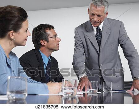 Three business colleagues in conference meeting View Large Photo Image Stock Photography - Three business colleagues in conference meeting. Fotosearch