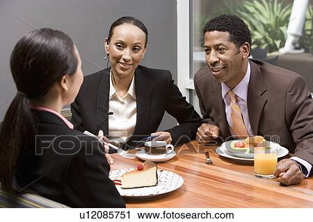 Three business people having lunch View Large Photo Image Stock Image - Three business people having lunch. Fotosearch