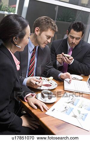 Three business people having meeting at lunch View Large Photo Image Stock Image - Three business people having meeting at lunch. Fotosearch