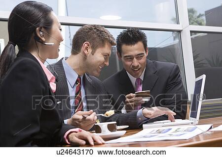 Three business people having meeting at lunch View Large Photo Image Stock Image - Three business people having meeting at lunch. Fotosearch