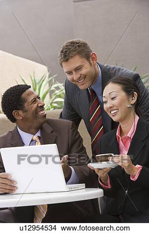 Picture - Three business people having meeting. Fotosearch