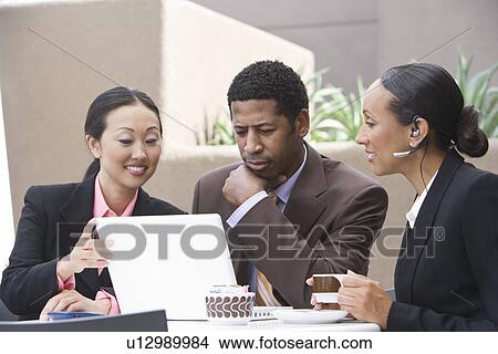 Picture - Three business people having meeting. Fotosearch