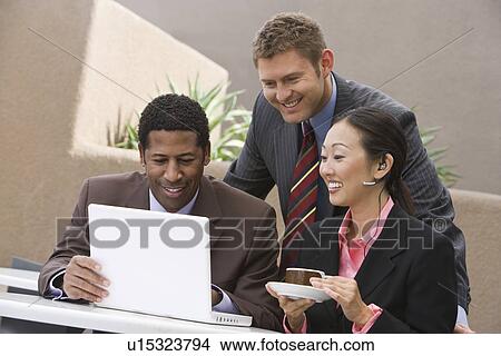 Picture - Three business people having meeting. Fotosearch