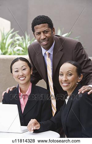 Stock Photo - Three business people having meeting. Fotosearch