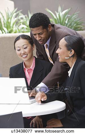 Three business people having meeting View Large Photo Image Stock Photo - Three business people having meeting. Fotosearch