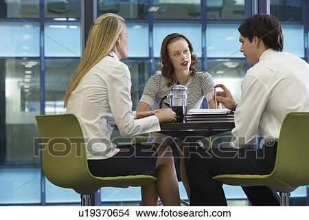 Three businesspeople taking a coffee break View Large Photo Image Picture - Three businesspeople taking a coffee break. Fotosearch