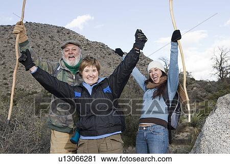 Three cheering hikers View Large Photo Image Stock Image - Three cheering hikers. Fotosearch