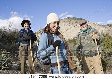 Stock Photograph - Three hikers on a trail. Fotosearch
