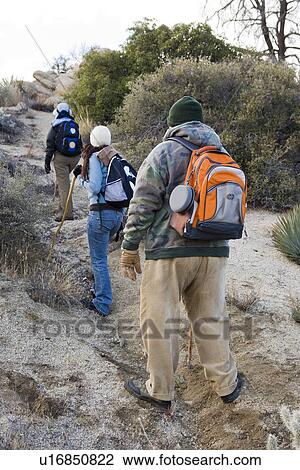 Stock Image - Three hikers on the trail. Fotosearch