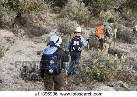 Three hikers on the trail View Large Photo Image Stock Photograph - Three hikers on the trail. Fotosearch