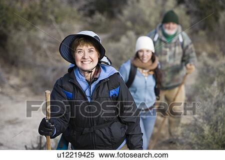 Stock Photography - Three hikers on trail. Fotosearch
