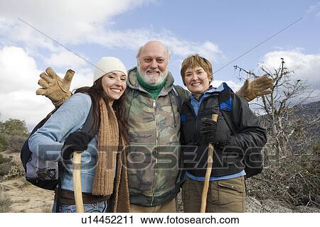 Stock Image - Three hikers standing on the trail. Fotosearch