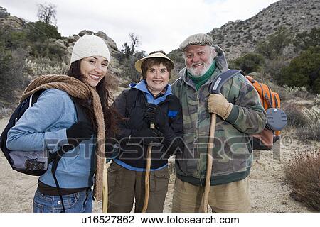 Stock Image - Three people hiking, portrait. Fotosearch