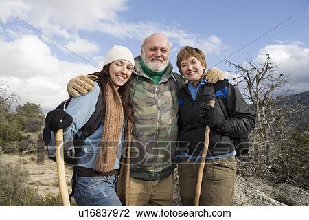Stock Image - Three people on hiking trip in mountains, portrait. Fotosearch
