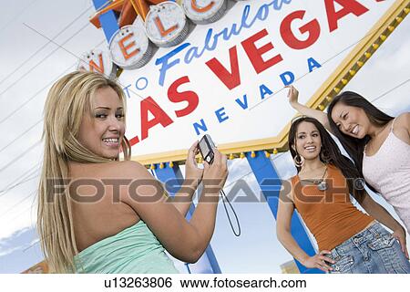 Three women taking picture in front of Las Vegas welcome sign, Nevada, USA View Large Photo Image Stock Photograph - Three women taking picture in front of Las Vegas welcome sign, Nevada, USA. Fotosearch